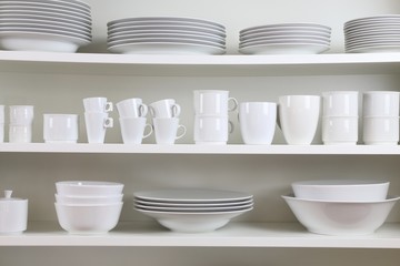 white dishes on a white shelf

