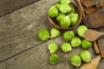 Brussels sprouts on old wooden table. Homework fresh vegetables. Growing vegetables on the farm. Preparing vegetarian food. Diet food.