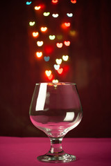 Wine glass with a light heart shaped bokeh in the background