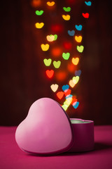 Pink gift box open shaped heart with Defocused bokeh colorful li