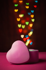 Pink gift box open shaped heart with Defocused bokeh colorful li