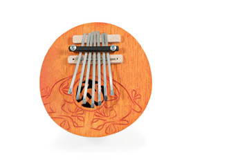 African round played by plucking musical instrument Kalimba, with carved ornaments, isolated on...