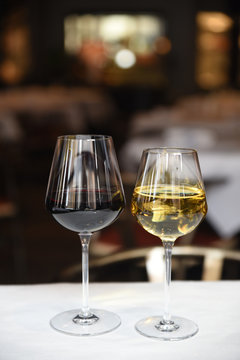 Glasses of red wine and white wine served on the table