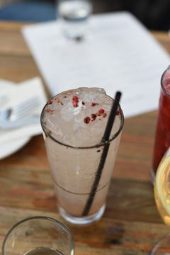 Cocktail garnished with pink peppercorns 