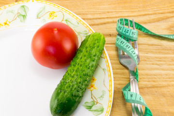 Measuring tape and a fork with tomato isolated