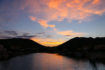 orange sunset and clouds on the dark blue sky in  mountain, silhouette.