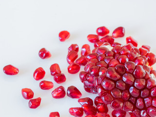pomegranate seeds on white background