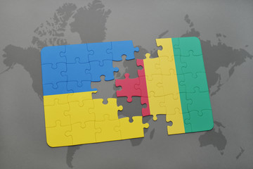 puzzle with the national flag of ukraine and guinea on a world map