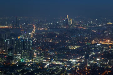 Fotobehang View of downtown in Seoul, South Korea, from above at night. © tuomaslehtinen