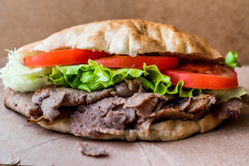Turkish Pide Doner Sandwich with greens and tomatoes.