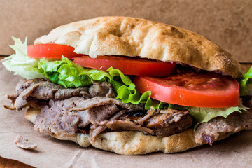 Turkish Pide Doner Sandwich with greens and tomatoes.