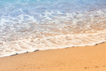 Fototapeta na wymiar Wave of the sea on the sand beach