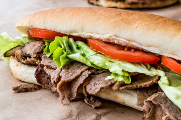 Turkish Pide Doner Sandwich with greens and tomatoes.
