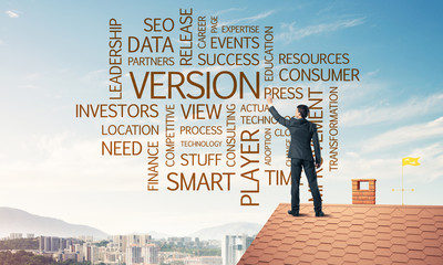 Young businessman standing on house roof and writing leadership 