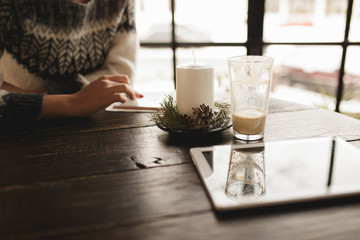 Cropped shot of a woman hand using touchscreen in a cafe