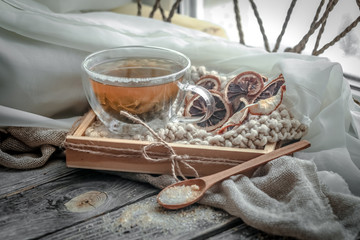 Fototapeta na wymiar still life with transparent Cup of tea on wooden background