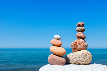 Concept of harmony and balance. Rock Zen on the background of summer sea