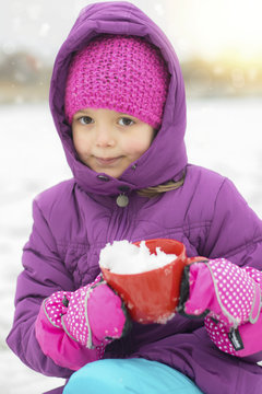 Little girl playing in the snow