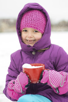 Little girl playing in the snow