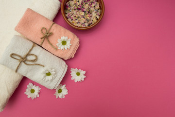Spa and wellness setting with flowers and towels.