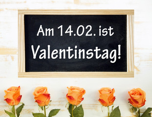 roses and chalkboard with german words for Happy Valentines Day