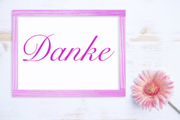 pink flower with frame and german word for Thank You