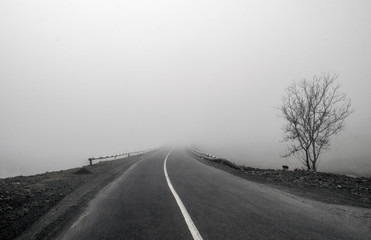 Foggy Country Road. Fog creates a feel of emptiness as it leads to seemingly nowhere. Ilisu, Gakh, Azerbaijan