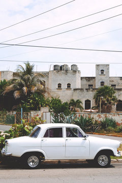 Vintage white car outside building