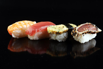 close up of sashimi sushi set with chopsticks and soy - sushi roll with salmon and sushi roll with...