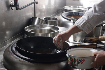 Close up of working chef preparing chinese food