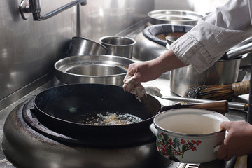 Close up of working chef preparing chinese food