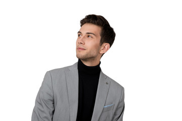 the young  guy in a jacket and jeans looks upward