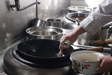 Close up of working chef preparing chinese food