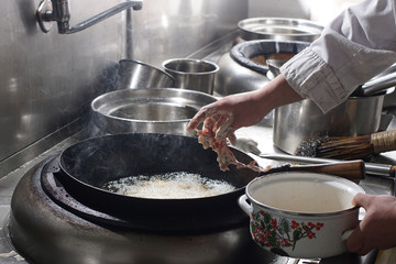 Close up of working chef preparing chinese food
