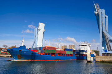 Fototapeta premium Industrial ship going out from a open drawbridge, Porto