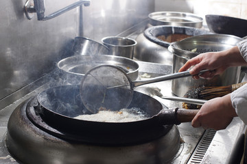 Close up of working chef preparing chinese food