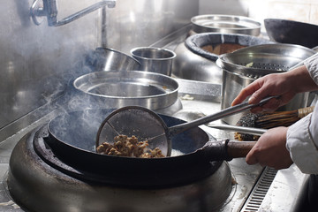 Close up of working chef preparing chinese food