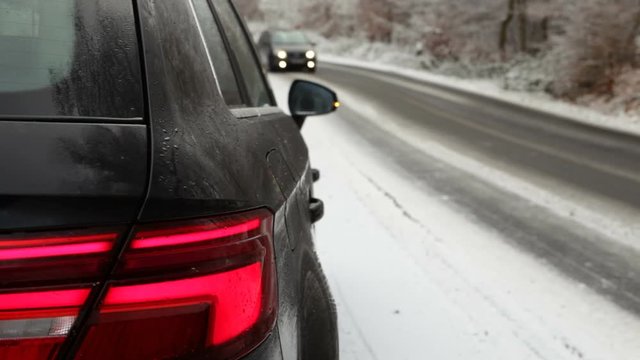Close-up of car blinker - winter road and traffic