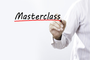 Businessman hand writing Masterclass with red marker on transpar