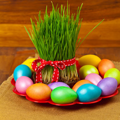 Colored eggs, wheat springs Nowruz Holiday in Azerbaijan. Selective focus.