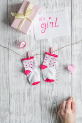 birth of girl - baby shower concept on wooden background