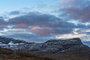Mountain range covered in snow at dusk