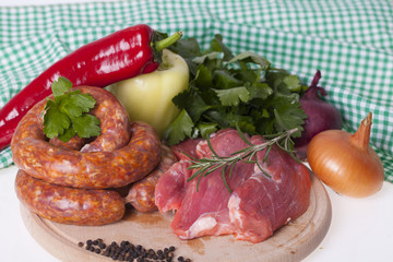 raw homemade sausages and fresh pork meat