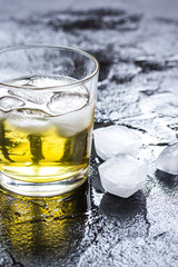 glass of whiskey on dark background
