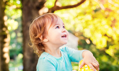 Happy toddler girl smiling outside