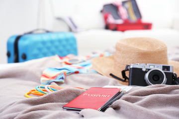 Clothes prepared to packaging in traveler case on bed, closeup