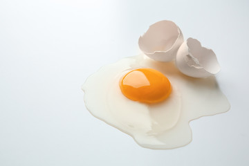 Raw egg yolk on white background