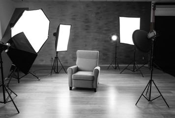 Photo studio with modern interior and lighting equipment