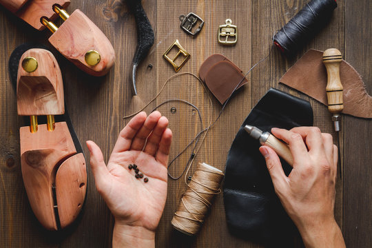 cobbler tools in workshop dark background top view