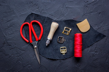 leather craft instruments on dark background top view mock up